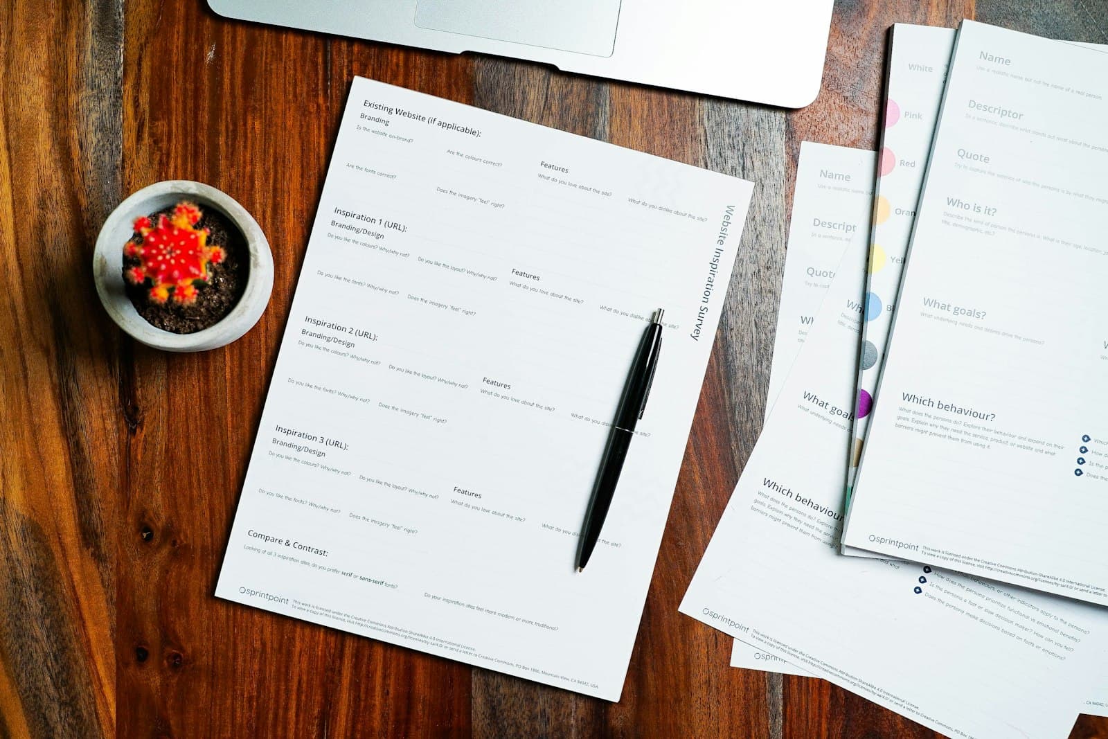 Business filings and a pen laid out on a wooden desk