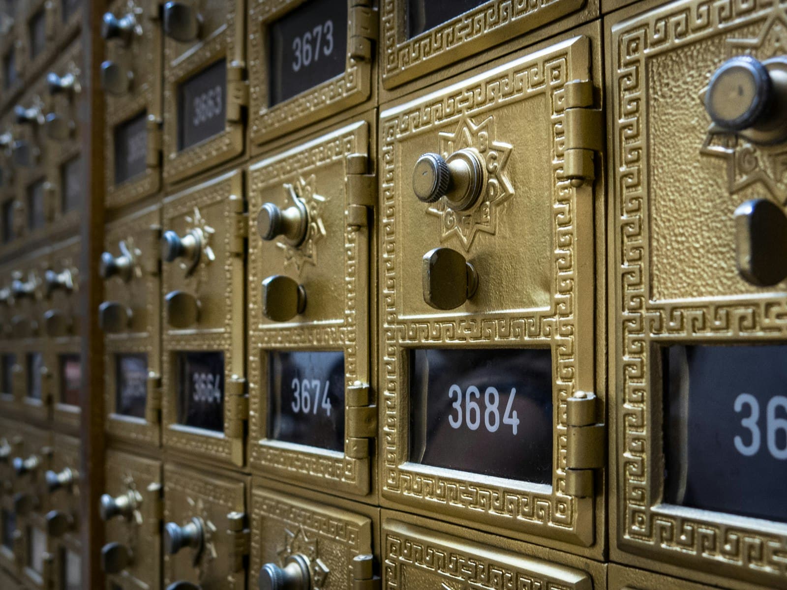 Rows of numbered brass mailboxes for receiving official mail