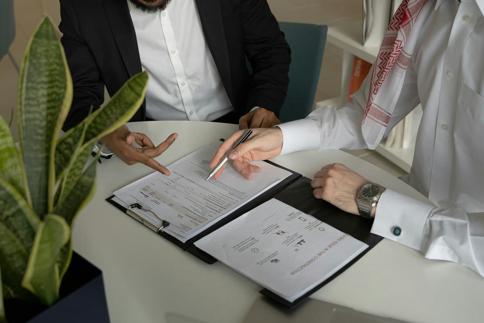 Business owner reviewing and signing filing forms with an advisor
