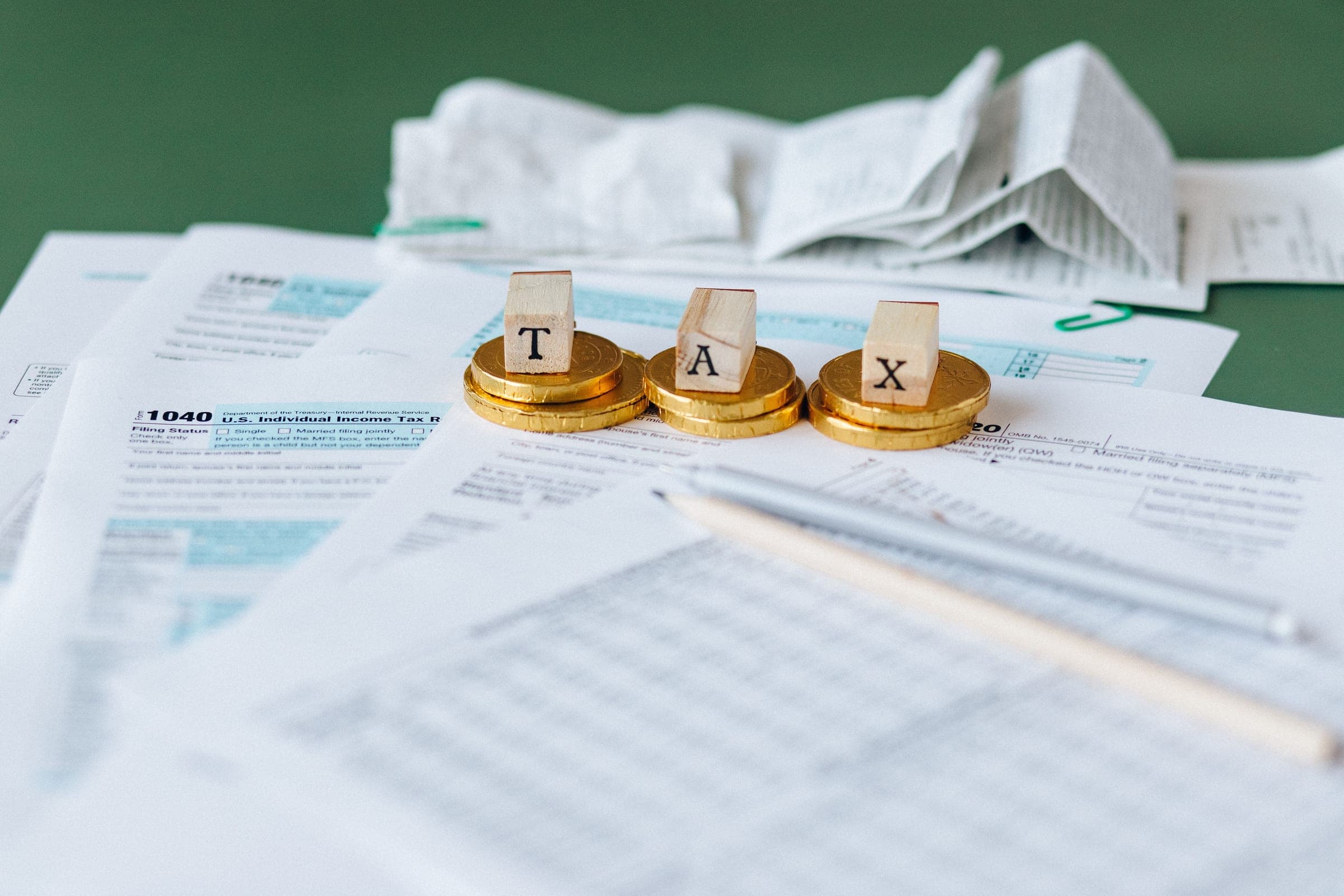 Wooden tax blocks and coins on IRS tax forms