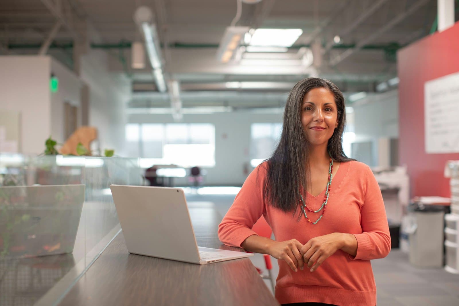 Smiling small-business owner standing in her workshop