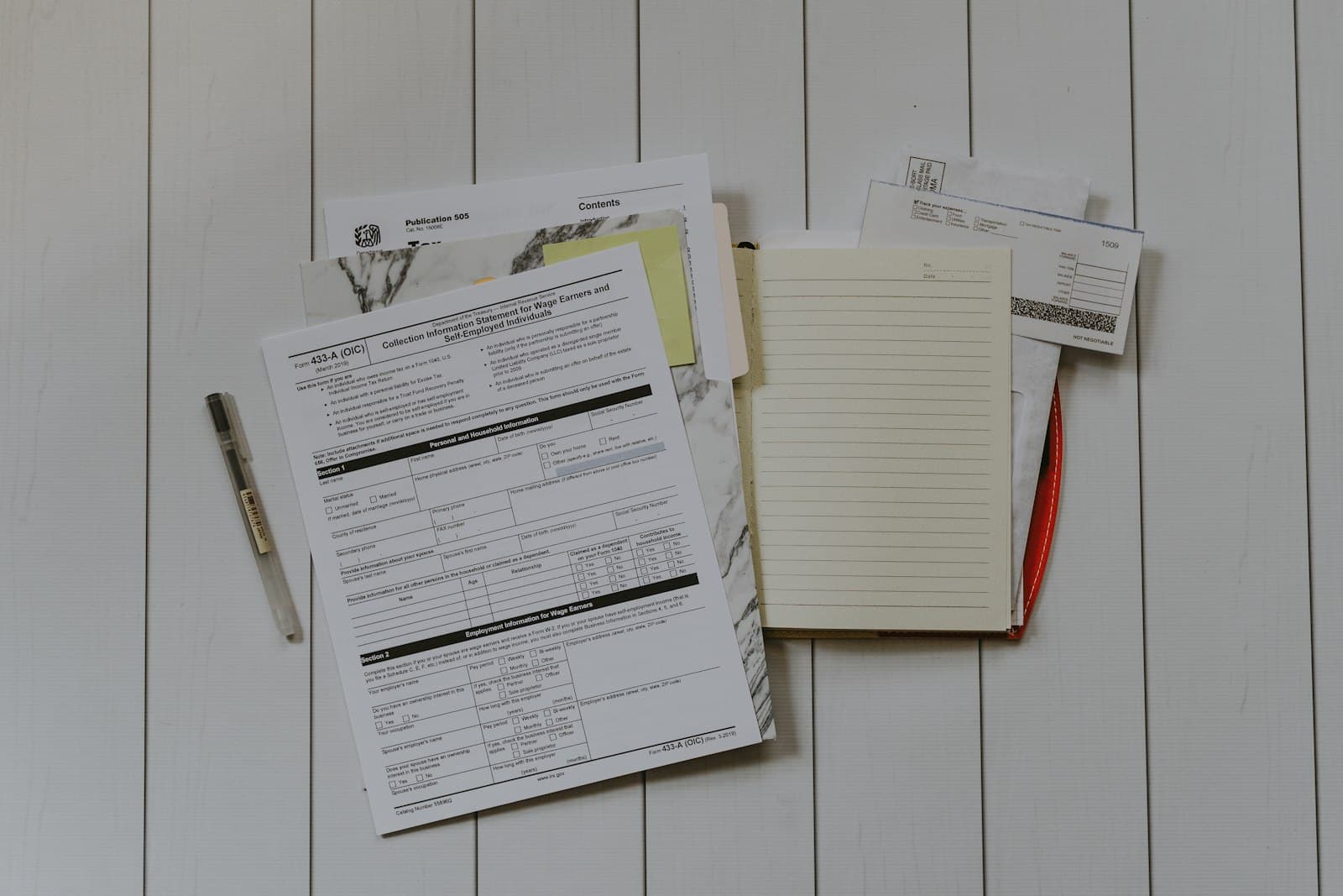 Past tax forms and notes laid out on a desk for review