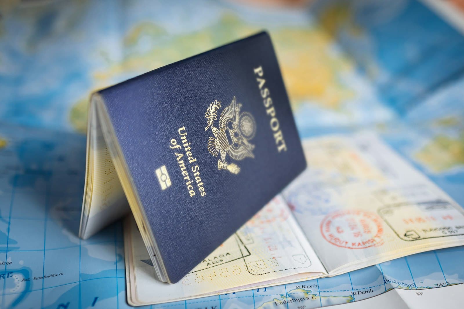 Passport resting on a world map, a supporting document for an ITIN application