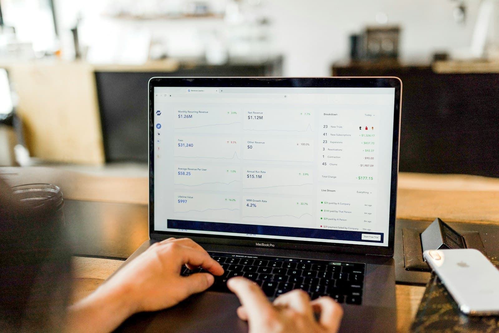 Hands working on a laptop at a bright desk, preparing a return remotely